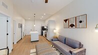 Located at 900 S Sarah St in St. Louis, MO, this thoughtfully designed one-bedroom, one-bathroom unit offers a efficient and modern living experience across a single floor. The open-concept layout seamlessly connects the kitchen and living area, creating a bright and welcoming atmosphere enhanced by light hardwood flooring and recessed lighting throughout.

The kitchen is a standout feature, boasting white shaker cabinetry with matte black hardware, a teal subway tile backsplash, stainless steel appliances including a refrigerator, range, microwave, and dishwasher, and a central island with a clean white countertop illuminated by stylish pendant lights. A ceiling fan overhead serves the adjacent living area, which offers ample room for seating and a dining nook.

The bedroom is a calm, light-filled retreat with tall ceilings, a large window with natural light, and direct access to the bathroom. The bathroom features a glass-enclosed shower, white vanity, and an adjacent walk-in closet with built-in shelving. Throughout the unit, neutral tones, tall ceilings, and consistent hardwood-style flooring lend a cohesive, contemporary aesthetic that maximizes the sense of space.