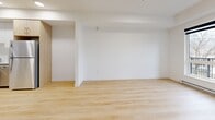 This contemporary apartment in Vernon, BC offers 710 square feet of thoughtfully designed living space. The open-concept layout maximizes the use of space, creating a seamless flow between living areas. Large windows flood the rooms with natural light, enhancing the sense of spaciousness and providing picturesque views of the surrounding mountains.

The kitchen is a standout feature, boasting modern white cabinetry complemented by light wood lower cabinets. Stainless steel appliances, including a range, refrigerator, and dishwasher, add a touch of sophistication. The living area is versatile, easily accommodating both lounging and dining functions.

The bedroom offers ample space and features a large closet with sliding doors for efficient storage. The bathroom is sleek and functional, with a glass-enclosed shower/tub combination and a modern vanity.

Throughout the apartment, light-toned wood-look flooring creates a warm, inviting atmosphere. The balcony, accessible from the main living area, provides an outdoor retreat with stunning mountain vistas. This well-designed space combines style and functionality, perfect for modern urban living in the heart of British Columbia's Okanagan Valley.