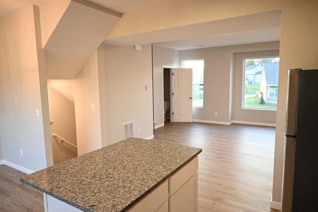 A view from the Kitchen Island into the Great Room. - 3467 Glenbrook Cir N