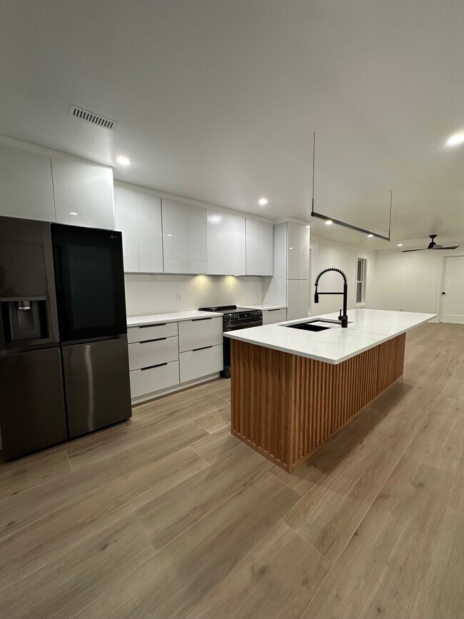 Kitchen with fridge, range, microwave, and dishwasher - 1285 W 67th St