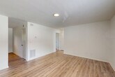 Located at 1050 Villa Ct SE in Atlanta, GA, this well-appointed one-bedroom, one-bathroom unit offers a clean and functional layout across a single floor. The open living area welcomes you with light wood-look flooring, crisp white walls, and a ceiling-mounted light fixture, creating a bright and airy atmosphere. A doorway connects the living space seamlessly to the rest of the unit.

The kitchen is a standout feature, equipped with white shaker-style cabinetry, a classic white subway tile backsplash, stainless steel appliances including a refrigerator and dishwasher, and a single-basin sink. Track lighting overhead and a window with exterior access add both practicality and natural light to the space.

The bedroom is a comfortable retreat featuring plush carpeting, a ceiling fan with light, a generous double-door closet, and windows dressed with blinds that invite natural light while maintaining privacy.

The bathroom is thoughtfully designed with white penny tile flooring, full subway tile surround on the tub-shower combination, and brushed gold fixtures that lend a touch of elegance. A window above the tub provides natural ventilation.

Throughout the unit, the consistent use of light tones and clean finishes creates a cohesive, move-in-ready feel.