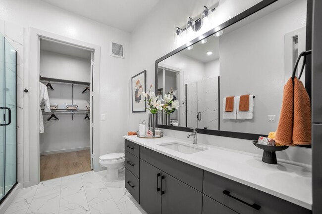 Experience luxury in this modern bathroom, featuring sleek design and ample storage space. - The Emory