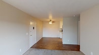 Located at 532 Broadway in El Cajon, this single-story unit offers a practical and well-organized layout designed for comfortable everyday living. The main living area features a combination of plush carpeting and wood-style flooring, creating a clear visual distinction between the lounge and dining zones. A ceiling fan overhead adds both function and a finished look, while a front entry door with a security panel provides convenient access. Natural light filters in through a sliding glass door fitted with vertical blinds, brightening the carpeted living space.

The galley-style kitchen is efficiently designed, offering granite-patterned countertops, white cabinetry, a double-basin sink, and black appliances including a range and refrigerator. Wood-style flooring continues through this space, contributing to a cohesive feel.

The bedrooms are carpeted and feature ceiling fans, with one room including a walk-in closet with built-in shelving and a window with vertical blinds for natural light. An additional carpeted room offers flexible use as a bedroom or secondary space.

The bathroom is appointed with a granite-topped vanity, white cabinetry, a well-lit mirror with globe lighting, and a full tub-shower combination, delivering a clean and functional finish throughout.