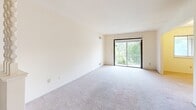 Located at 5984 Boise Ile Dr in Haslett, Michigan, this single-floor home offers four bedrooms and two full bathrooms across a well-organized layout. The galley-style kitchen is equipped with dark wood cabinetry, a double-basin sink, a gas range with overhead ventilation, and a full-size refrigerator, with vinyl flooring and ample counter space along both walls. The living area is open and bright, featuring neutral carpet, a decorative room divider, and a built-in closet with louvered doors. The generously sized primary bedroom includes a walk-in closet area and an additional built-in closet, offering substantial storage. The remaining bedrooms are carpeted and well-lit, each featuring windows that bring in natural light and views of the surrounding greenery, along with their own closet space. The two bathrooms serve the home efficiently — one features tile flooring with a tub and shower combination, a vanity with countertop sink, and a wall-mounted mirror, while the second features mosaic tile flooring and a clean, functional layout. Multiple hallways connect the rooms throughout the home, providing a logical and accessible flow. The neutral color palette and practical finishes make this a straightforward and functional living space.