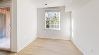 This contemporary apartment, located at 8732 Town and Country Blvd in Ellicott City, MD, offers a harmonious blend of comfort and style. The single-floor layout promotes easy living, with each room thoughtfully designed for maximum functionality. Upon entering, you're greeted by an open concept living area, adorned with plush carpeting and bathed in natural light from large windows. The kitchen boasts sleek, white cabinetry complemented by stainless steel appliances and light wood flooring, creating a bright and inviting culinary space. The bathroom features a modern design with a combination tub-shower, white tilework, and a vanity with ample storage. Bedrooms are spacious and carpeted, with one room offering hardwood flooring for versatility. A standout feature is the private balcony, accessible through sliding glass doors, providing a serene outdoor space with views of the surrounding greenery. The apartment also includes a walk-in closet with wire shelving, ensuring plenty of storage options. Throughout the space, crisp white walls and recessed lighting contribute to the overall airy and modern ambiance.