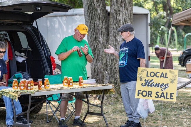 Customers learn about local honey at the Latrobe Farmers Market.
