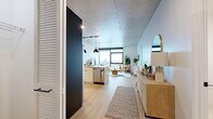 Located in Chicago's vibrant West Loop neighborhood, this 1-bedroom, 1-bathroom unit at 225 N Elizabeth offers a thoughtfully designed open-concept layout with contemporary finishes throughout. Exposed concrete ceilings lend an industrial character to the space, while light wood-tone flooring runs continuously through the living, kitchen, and bedroom areas, creating a cohesive and airy atmosphere.

The kitchen is well-appointed with two-tone cabinetry—matte dark upper cabinets contrasting with white lower cabinets—stainless steel appliances including a gas range and French door refrigerator, and a peninsula that doubles as a breakfast bar. The open layout flows seamlessly into the living area, which is anchored by a large floor-to-ceiling window offering sweeping city views and abundant natural light.

The bedroom continues the bright, modern aesthetic with its own floor-to-ceiling window framing elevated Chicago skyline views. A dedicated walk-in closet provides generous storage with built-in shelving and hanging rods. The bathroom features a sleek dark-cabinet vanity, illuminated mirror, and clean white tile finishes. Additional conveniences include an in-unit laundry area. The unit delivers a refined urban living experience with modern industrial design elements throughout.