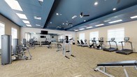 The fitness center at Capital Place At Southwood is a well-appointed, single-floor facility designed to support a comprehensive workout experience. The space features a striking two-tone ceiling design, with deep navy blue recessed sections contrasting against the lighter surrounding areas, giving the room a modern, polished aesthetic. Multiple ceiling fans and recessed lighting ensure the space remains comfortable and well-illuminated throughout.

The layout is generously sized, offering ample room between equipment stations to move freely. Along one wall, a large floor-to-ceiling mirror visually expands the space while allowing users to monitor their form. Flat-screen televisions are mounted for entertainment during workouts.

The equipment selection is diverse and well-organized. Cardio machines, including ellipticals and stationary bikes, are arranged along one side of the room, while a dedicated free weight area features a full rack of dumbbells and various resistance equipment. Strength training stations, including a power tower for bodyweight exercises, occupy the central floor space.

Neutral-toned, textured carpet tiles cover the floor throughout, providing both durability and comfort. Natural light filters in through several windows, enhancing the open and inviting atmosphere of this fitness facility.