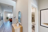 Located at 22824 Terrazzo Drive in Katy, TX, this well-appointed two-story home offers 3 bedrooms and 4 bathrooms across two thoughtfully designed floors. The main level features light wood-look flooring throughout, anchored by a bright and open living room with neutral tones and modern finishes. The kitchen is a standout, boasting rich dark cabinetry, granite countertops, stainless steel appliances, a subway tile backsplash, and a generous island with bar seating — ideal for both everyday cooking and entertaining. The adjacent dining area includes a built-in window seat framed by large windows, filling the space with natural light, and provides direct access to the outdoors. A dedicated office on the main floor offers a quiet, functional workspace with natural light from a window overlooking the exterior. Upstairs, the spacious primary bedroom features plush carpet, a ceiling fan, and dual windows with neighborhood views. It is complemented by a walk-in closet and well-appointed en-suite. Additional bedrooms are bright and comfortably sized, each with windows and carpeted floors. The bathrooms are finished with clean, light grey tile. A dedicated laundry room with a full-size washer and dryer adds everyday convenience. The home combines modern design with practical functionality throughout.