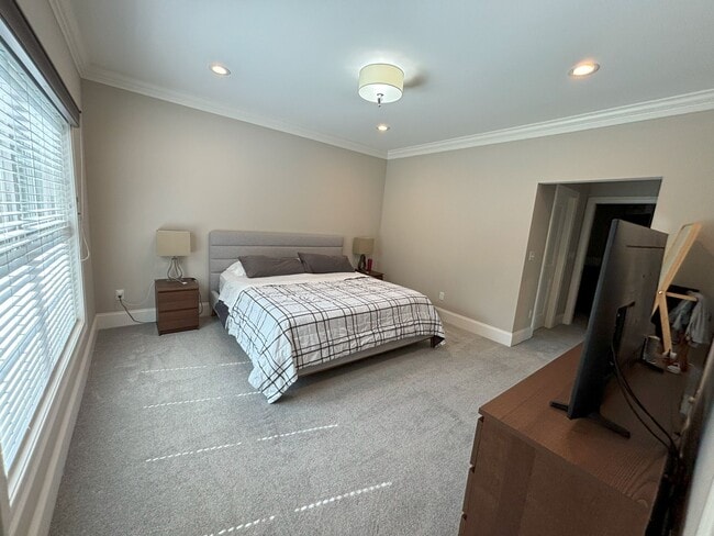 Main floor, main bedroom suite with walk in closet and full bathroom attached. Carpet flooring. - 140 Wells View Rd