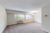 Located at 700 Sligo Ave in Silver Spring, Maryland, this well-appointed 2-bedroom, 1-bathroom residence offers a comfortable and functional single-floor layout. The combined living and dining area is expansive, featuring soft wall-to-wall carpeting, neutral tones, and multiple windows dressed with blinds that invite natural light while offering views of the surrounding greenery. An elegant chandelier anchors the dining area, adding a refined touch to the open space.

The kitchen is efficiently designed with a galley-style layout, showcasing granite countertops, white cabinetry, hardwood-style flooring, and track lighting overhead. It is equipped with a gas range, refrigerator, and the added convenience of an in-unit washer.

Both bedrooms are carpeted and feature individual climate control units and windows that bring in natural light. The spacious primary bedroom includes a walk-in closet, while the second bedroom offers a comfortable, versatile space. The unit is served by five closets throughout, providing excellent storage.

The full bathroom includes a tub/shower combination with a clean, classic finish. A hallway connects the rooms, creating a cohesive and easy-to-navigate floor plan throughout this well-maintained Silver Spring residence.