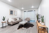 Located in West Jordan, Utah, this thoughtfully designed single-floor home offers four bedrooms and two bathrooms within a well-organized layout. The open-concept kitchen and living area serves as the heart of the home, featuring white shaker cabinetry, stainless steel appliances, a peninsula with bar seating, pendant lighting, and light wood-style flooring. The adjacent living room provides a welcoming, airy atmosphere with large sliding doors that invite natural light and connect to the exterior. The bedrooms are finished with plush carpeting and neutral tones; the primary bedroom offers a comfortable, private retreat, while a dedicated walk-in closet provides ample storage with wrap-around hanging rods. Additional bedrooms feature windows that bring in natural light, enhancing their bright and calm character. The two bathrooms are clean and modern, outfitted with white vanities, wood-look tile flooring, and a tub-shower combination. Hallways connect the spaces efficiently, and the overall color palette of soft grays and whites lends a cohesive, contemporary feel throughout. The single-level floor plan ensures easy accessibility, making this a practical and stylish home in a convenient West Jordan location.