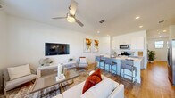 This contemporary residence in Lakewood Ranch, Florida, offers 1500 square feet of thoughtfully designed living space across two floors. The home boasts three bedrooms and four bathrooms, providing ample space for comfortable living and entertaining.

The ground floor, spanning 770 square feet, features an open-concept layout that seamlessly integrates the kitchen, living, and dining areas. The kitchen is equipped with modern appliances, light wood cabinetry, and a sleek island with a sink, perfect for meal preparation and casual dining. Large windows flood the space with natural light, while sliding glass doors lead to an outdoor patio area.

Upstairs, the 730-square-foot second floor houses the bedrooms, including a spacious 170-square-foot primary suite. The bedrooms are well-appointed with plush carpeting, ceiling fans, and large windows offering picturesque views. The bathrooms feature contemporary fixtures, wood-look flooring, and ample storage space.

Throughout the home, a neutral color palette with pops of warm tones creates a welcoming atmosphere. Hardwood floors, modern light fixtures, and stylish furnishings contribute to the overall aesthetic. The property also includes a utility room and multiple closets for added convenience and storage.

With its blend of functionality and style, this Lakewood Ranch home offers a comfortable and contemporary living experience in a desirable Florida location.