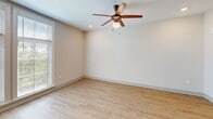 Located in the heart of Charleston's historic East Bay corridor, this well-appointed 2-bedroom, 1-bathroom residence offers a clean, modern aesthetic across a single thoughtfully designed floor. Light wood-style flooring flows throughout the main living areas and kitchen, lending a bright, cohesive feel to the space.

The open-concept kitchen and living room serve as the heart of the home. The kitchen is outfitted with white shaker cabinetry, granite countertops, a subway tile backsplash, and a full suite of stainless steel appliances including a refrigerator, range, microwave, and dishwasher — all set against recessed lighting and generous cabinet storage.

The living area benefits from large windows that invite abundant natural light and views of surrounding greenery, complemented by a ceiling fan overhead.

Both bedrooms are carpeted for comfort and each feature ceiling fans. The primary bedroom offers a comfortable footprint, while both rooms are served by closets with built-in wire shelving for organized storage.

The full bathroom is finished with a granite-topped vanity with dark hardware, a tub-shower combo with tile surround, and wood-look tile flooring. A well-lit hallway with modern paneled doors and recessed lighting connects all rooms seamlessly, completing this clean and functional Charleston residence.