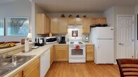 Located at 1900 Soldiers Dr in Findlay, Ohio, this single-floor residence offers a thoughtfully designed open-concept layout that seamlessly connects the main living areas. The kitchen is outfitted with light maple cabinetry, ample counter space, and full appliances including a range, refrigerator, and dishwasher, and flows naturally into a dedicated dining area with rich hardwood-style flooring throughout.

The living room is bright and welcoming, featuring hardwood-style floors and a sliding glass door that opens to an outdoor patio with open views of the surrounding landscape. A dedicated home office provides a quiet, functional workspace with its own window and hardwood-style flooring.

The bedroom is generously sized, offering plush carpeting, a ceiling fan with light fixture, and a window that fills the room with natural light. The primary bathroom includes a walk-in shower, an extended vanity with a large mirror, and light maple cabinetry. A second bathroom features a full soaking tub with shower, wood-style flooring, and a vanity with matching cabinetry.

A dedicated in-unit laundry room houses a full-size washer and dryer with built-in shelving above for convenient storage. The neutral color palette and consistent finishes throughout the home create a cohesive, move-in-ready living environment.