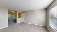 Located at 405 Foxfire Dr in Columbia, SC, this single-floor home offers a well-organized layout with 2 bedrooms, 3 bathrooms, a living room, kitchen, hallway, and two closets. The living room features neutral-toned carpet, clean white baseboards, and a front entry door with a sidelight window that allows natural light to filter in, creating a bright and welcoming atmosphere. The primary bedroom is generously sized with plush carpet flooring, a dedicated closet with bifold doors, and ample wall space. The second bedroom also features carpet and benefits from a window that brings in natural light. The kitchen is equipped with white cabinetry, dark granite-style countertops, a double-basin sink, a black dishwasher, a black refrigerator, and light wood-look flooring. Notably, in-unit laundry is conveniently located within the kitchen area. The three bathrooms are consistently finished with white vanities, dark countertops, mirrored medicine cabinets, and light wood-look tile flooring, with at least one bathroom featuring a bathtub-shower combination. Neutral warm-gray walls are carried throughout the home, lending a cohesive and clean aesthetic to every room.