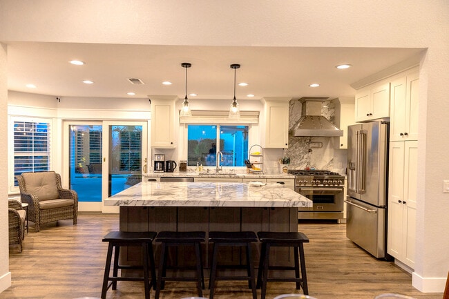 Cook with ease in the fully equipped kitchen featuring a 6-burner stove, essential utensils - 5506 Malachite Ave