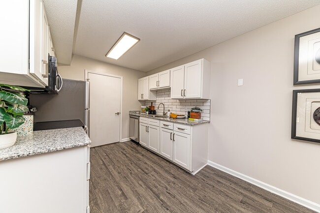 Kitchen with granite counters and modern cabinetry - The Alexander Apartment Homes