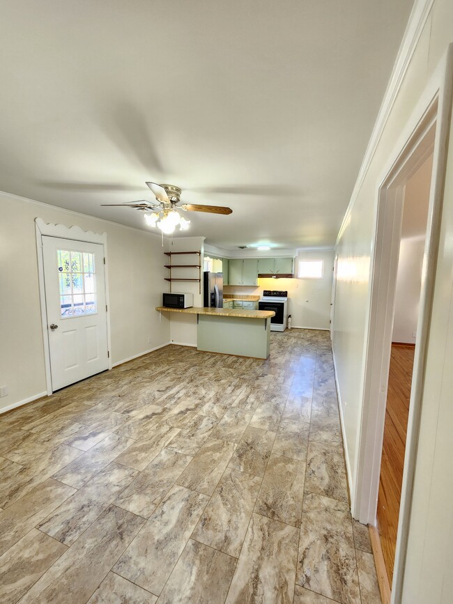 Dining room and kitchen with door to extra large deck and fenced back yard. - 139 Saratoga Dr