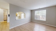 This single-story residence in Speedway, IN offers a generous 1180 square feet of living space, comprising 5 bedrooms and 2 bathrooms. The home's layout includes a dining room, kitchen, living room, and a closet, providing ample space for family living and entertaining. The primary bedroom is particularly spacious at 200 square feet.

Throughout the home, light-colored walls and warm wood-tone flooring create a bright, welcoming atmosphere. The bathrooms feature modern white fixtures, including a bathtub-shower combination with a sliding glass door. The kitchen is equipped with stainless steel appliances, granite countertops, and wooden cabinetry, offering both functionality and style.

Large windows in the bedrooms and living areas allow for plenty of natural light, while sliding glass doors in one room provide direct access to the outdoor space. The home's neutral color palette and clean lines make it an ideal canvas for various decorating styles. A smart thermostat on the wall indicates modern climate control features, enhancing comfort and energy efficiency.