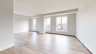 This well-appointed 2-bedroom, 2-bathroom unit at 6450 Bayers Road in Halifax, NS offers a thoughtfully designed single-floor layout with a clean, contemporary aesthetic. Light hardwood flooring flows seamlessly throughout, complementing the bright white walls and neutral palette that define the space.

The open-concept kitchen, dining, and living area forms the heart of the unit. The kitchen features sleek white cabinetry, dark countertops, stainless steel appliances including a refrigerator and range, and a functional island with a pendant light fixture overhead. Large windows bring in natural light and views of the surrounding neighbourhood.

Both bedrooms are generously proportioned, with the primary bedroom offering multiple closets with built-in shelving and rail systems for ample storage. Each bedroom benefits from natural light through well-placed windows with neighbourhood views.

The two bathrooms are finished in a clean, modern style. One features a glass-enclosed walk-in shower with white tile surround and matte black hardware accents, while the second includes a soaker tub with glass shower enclosure. Both bathrooms continue the light hardwood flooring found throughout the unit.

A dedicated laundry room houses a stacked Whirlpool washer and dryer, adding everyday convenience. A central hallway with three closets connects all areas of the unit efficiently.