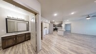 This well-appointed 2-bedroom, 2-bathroom residence in Ingleside offers a thoughtfully designed single-floor layout with consistent wood-look flooring throughout. The open kitchen and living area serves as the heart of the home, featuring rich dark-stained cabinetry, granite-look countertops, stainless steel appliances including a range, microwave, and dishwasher, and a peninsula with a deep undermount sink. A dedicated in-unit laundry area is conveniently accessible directly from the kitchen. The living room offers natural light through blinded windows and a clean, neutral palette that complements the warm flooring. The primary bedroom is a comfortable retreat, equipped with a ceiling fan, natural light from dual windows, and direct access to a dedicated closet. The primary bathroom features dark cabinetry with granite countertops and a walk-in shower with white tile surround. The second bedroom also includes a ceiling fan, window, and its own walk-in closet. The second bathroom offers a full tiled tub-shower combo with brushed nickel fixtures. Neutral wall tones, recessed lighting, and modern two-panel interior doors provide a cohesive, contemporary aesthetic throughout the space.