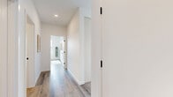 Located at 325 Royal Commons in Victoria, BC, this well-appointed 2-bedroom, 2-bathroom residence offers a thoughtfully designed single-floor layout with a clean, contemporary aesthetic throughout. Light hardwood flooring and crisp white walls create a cohesive, airy atmosphere from room to room.

The open-concept kitchen is a standout feature, showcasing flat-panel white cabinetry, light quartz countertops, a large island with bar seating, a matte black faucet, and stainless steel appliances — including a full-size refrigerator. A light blue tile backsplash adds a subtle accent to the modern design. The adjacent dining area is bathed in natural light through oversized windows that frame expansive outdoor views.

The living room is bright and welcoming, with large windows overlooking the surrounding landscape and a wall-mounted mini-split unit for climate control. The primary bedroom is a calm retreat with access to an ensuite bathroom featuring a glass-enclosed walk-in shower, white vanity, and wood-look tile flooring. The second bedroom benefits from its own generous window with scenic views. A second full bathroom includes a soaker tub with tile surround. A dedicated hallway and closet complete this efficiently organized home.