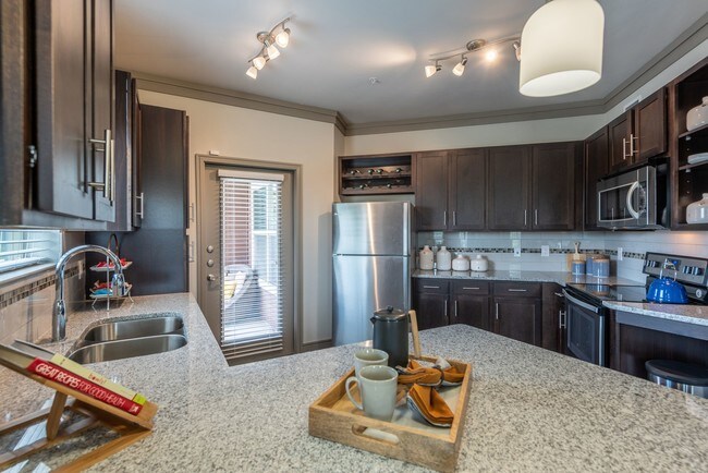 Sleek Granite Countertops and Stainless Steel Appliances - Cortland Windsong Ranch