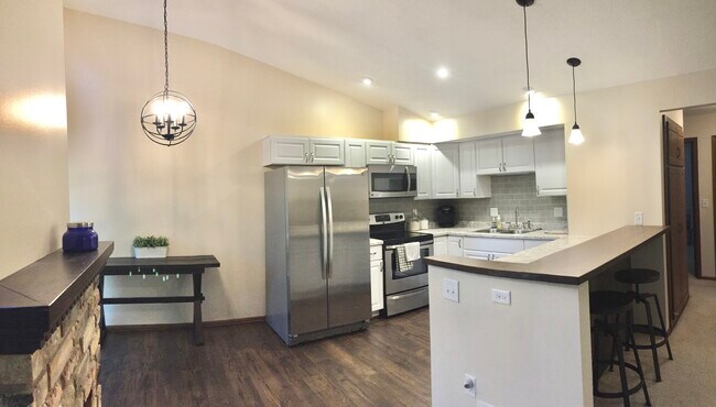 Fully remodeled kitchen with new stainless steel appliances, updated lighting and a custom bar height countertop. - 1511 Trapp Court