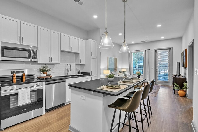 Experience contemporary elegance in this open plan kitchen and living room, perfect for stylish entertaining. - Livano Norfolk