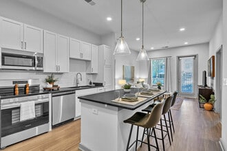 Experience contemporary elegance in this open plan kitchen and living room, perfect for stylish entertaining. - Livano Norfolk