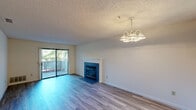 Located at 2851 Redwood Pkwy in Vallejo, California, this single-floor home offers four bedrooms and two full bathrooms in a practical and well-organized layout. The living room serves as the heart of the space, featuring light-toned hardwood-style flooring, a blue tile-surround fireplace with a white mantle, and a sliding glass door that opens to a balcony, filling the room with natural light and outdoor views. An elegant chandelier adds a classic finishing touch overhead, while a textured ceiling runs throughout the home. The kitchen is positioned adjacent to the living area and is equipped with white cabinetry and appliances, connected via a open pass-through layout that promotes easy flow between spaces. Each of the four bedrooms is carpeted and bright, with vertical blind-covered windows allowing natural light in. Several bedrooms feature sliding glass door access, extending the sense of openness. A dedicated closet provides additional storage. The two bathrooms are clean and functional, each featuring a full tub-shower combination, toilet, and a large wall mirror. A hallway connects the rooms efficiently, completing the streamlined single-floor floor plan. This home offers a comfortable and practical living environment in the Vallejo community.