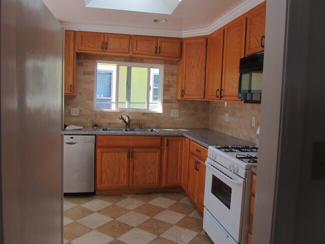 Kitchen,view with microwave, stove, microwave, refrigerator very clean and all working - 660 Flower Ave