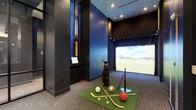 This single-floor indoor sports simulation facility is designed to deliver an immersive multi-sport experience within a contemporary, well-appointed environment. The space is defined by its bold navy blue and dark charcoal walls, creating an energetic yet focused atmosphere ideal for recreational play and athletic practice.

At the heart of the room is a large, high-definition simulator screen that projects a realistic golf course environment, making it suitable for golf simulation as well as other virtual sports experiences. The setup is complemented by a dedicated control station with a monitor, allowing users to navigate and manage the simulation software with ease.

The flooring combines durable carpet with a central artificial turf mat, providing a practical surface for swinging and playing. A full golf bag with clubs is positioned and ready for use, while an assortment of sports equipment — including a basketball, hockey sticks, a baseball tee, and various balls — highlights the space's versatility across multiple sports disciplines.

Recessed ceiling lighting ensures consistent, glare-free illumination throughout the room, supporting optimal visibility during use. Structural columns are incorporated into the design in a streamlined fashion, maintaining a clean and uncluttered layout. Overall, this space offers a well-equipped, purpose-built environment for both casual recreation and focused sports training.