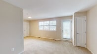 Located at 1632 N Hilton St in Baltimore, MD, this single-floor unit offers a functional and well-maintained layout designed for comfortable everyday living. The spacious living area is finished with plush wall-to-wall carpeting and neutral-toned walls that lend a clean, understated aesthetic throughout. Multiple windows along the main wall allow abundant natural light to fill the space, offering views of the surrounding neighborhood. A door from the living area provides direct outdoor access, adding convenience and additional ventilation.

The galley-style kitchen is efficiently designed with dark cabinetry offering ample storage, light countertops, and wood-look flooring. Stainless steel appliances—including a refrigerator, range, and dishwasher—are integrated seamlessly into the layout, providing a modern, practical cooking environment.

The bedroom is a well-proportioned room with carpeted flooring and a double window that brings in natural light while overlooking the exterior. A closet with louvered doors adds practical storage within the space.

The bathroom is cleanly finished with tile flooring, a wood-vanity with white countertop, and a tiled shower-tub combination with a chrome curtain rod. The overall ambiance of the unit is bright, neutral, and move-in ready.