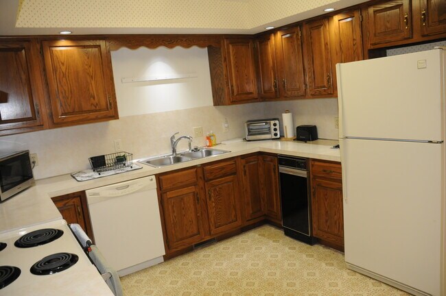 Kitchen with dish washer, microwave and trash compactor. - 21 Cambridge Ct