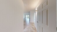 Located at 260 E Butterfield Rd in Elmhurst, IL, this well-appointed 2-bedroom, 2-bathroom residence offers a thoughtfully designed single-floor layout. The open living room is bright and generously sized, showcasing light hardwood-style flooring, a textured ceiling, and sliding glass doors that lead to an outdoor area, allowing natural light to fill the space. A chandelier accent adds a touch of warmth near the entryway.

The kitchen features tile flooring, granite countertops, white cabinetry, stainless steel appliances including a refrigerator and range, and a single-basin sink — combining functionality with clean, modern aesthetics. A closet conveniently adjacent to the kitchen adds practical storage.

The spacious primary bedroom offers ample room and includes a sliding double-door closet, while the second bedroom is bright with a window providing natural light and matching hardwood-style floors. Both bedrooms maintain a clean, neutral palette.

The two bathrooms are finished with stone-look tile flooring. One features a glass-enclosed walk-in shower with elegant tile surround, while the other includes a tub-shower combination with sliding glass doors and decorative mosaic tile accents. Together, these rooms reflect a cohesive, updated design throughout the residence.
