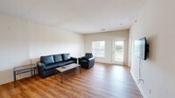 Located at 800 W Hovey Ave in Normal, IL, this three-bedroom, three-bathroom unit offers a practical and well-organized single-floor layout. The open living room is a welcoming central space featuring warm wood-look flooring, neutral walls, and large windows that bring in natural light. A wall-mounted TV setup and access to a private balcony make it an ideal area for both relaxing and entertaining.

The kitchen is equipped with wood-toned cabinetry, dark granite-style countertops, a black electric range, and a stainless steel sink. A notable convenience is the in-unit stacked washer and dryer, seamlessly integrated into the kitchen area.

Each of the three bedrooms is carpeted and fitted with a ceiling fan, providing comfort and airflow. The bedrooms offer dedicated study-friendly spaces, with windows in select rooms allowing for natural light. Each bedroom is paired with its own bathroom, featuring white-tiled tub and shower combinations — offering a private and functional setup ideal for shared living.

Three closets throughout the unit provide ample storage. A connecting hallway links the living areas to the private bedrooms, creating a clear and efficient flow throughout the home. The clean, neutral palette throughout the unit offers a versatile canvas for personalization.