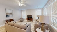 Located at 4816 Old Tyme Ct in Evansville, Indiana, this single-story home offers a thoughtfully designed layout across two bedrooms, three bathrooms, and a variety of functional living spaces. Light-toned luxury vinyl plank flooring flows throughout, complementing a neutral color palette that creates a bright and cohesive atmosphere.

The living room is a welcoming space featuring a ceiling fan, recessed lighting, and multiple windows that invite natural light. The dining area is distinguished by elegant wainscoting detail and a modern chandelier overhead. The kitchen is outfitted with crisp white cabinetry, stainless steel appliances, subway tile backsplash, and white quartz countertops.

The spacious primary bedroom includes a ceiling fan and generous closet space, while the en suite bathroom impresses with a dual-sink vanity featuring white shaker-style cabinetry, quartz countertops, and a tiled shower. The second bedroom is comfortably sized with a ceiling fan and ample natural light.

Additional highlights include a dedicated laundry room with full-size side-by-side washer and dryer, two closets with built-in shelving, and an attached garage with direct interior access. The home's clean, modern design and practical amenities make it an excellent choice in the Evansville area.
