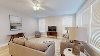 Located at 4816 Old Tyme Ct in Evansville, Indiana, this single-story home offers a thoughtfully designed layout across two bedrooms, three bathrooms, and a variety of functional living spaces. Light-toned luxury vinyl plank flooring flows throughout, complementing a neutral color palette that creates a bright and cohesive atmosphere.

The living room is a welcoming space featuring a ceiling fan, recessed lighting, and multiple windows that invite natural light. The dining area is distinguished by elegant wainscoting detail and a modern chandelier overhead. The kitchen is outfitted with crisp white cabinetry, stainless steel appliances, subway tile backsplash, and white quartz countertops.

The spacious primary bedroom includes a ceiling fan and generous closet space, while the en suite bathroom impresses with a dual-sink vanity featuring white shaker-style cabinetry, quartz countertops, and a tiled shower. The second bedroom is comfortably sized with a ceiling fan and ample natural light.

Additional highlights include a dedicated laundry room with full-size side-by-side washer and dryer, two closets with built-in shelving, and an attached garage with direct interior access. The home's clean, modern design and practical amenities make it an excellent choice in the Evansville area.