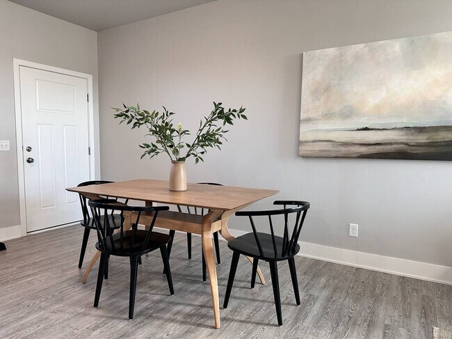 Open floor plan with dining area - 214 NW Common Pl