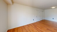 Located in Airway Heights, WA, this 3-bedroom, 2-bathroom single-floor unit offers a practical and well-organized layout across a comfortable footprint. The open-concept living area combines the kitchen, dining, and living spaces into one cohesive zone, anchored by warm hardwood-style flooring throughout. The kitchen features a peninsula with a double-basin sink, ample cabinetry with warm wood-tone finishes, and black appliances including a refrigerator, electric range, microwave, and dishwasher. The living room receives generous natural light through a large window and sliding glass door that opens to a private patio with outdoor views. Both bathrooms are finished with wood-tone vanity cabinetry, countertop sinks, large mirrors, and hardwood-style flooring. One bathroom includes a full shower-tub combo. The three bedrooms are carpeted and bright, each featuring closets — including sliding door closets — for ample storage. The primary bedroom offers a comfortable, well-proportioned space. Additional features include in-unit laundry and multiple closets throughout. The unit's neutral color palette and clean finishes create a move-in-ready environment suited for a variety of living arrangements.