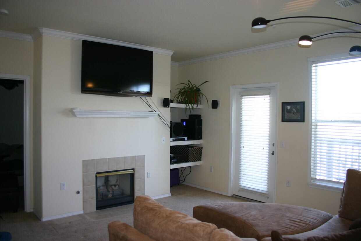 Living room with built-in TV mount and sound system - 18919 East Warren Circle
