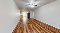 Located at 514 Finks Hideaway Rd in Monroe, Louisiana, this single-story 2-bedroom, 1-bathroom home offers a practical and comfortable layout. Rich wood-look laminate flooring flows consistently throughout every room, lending warmth and visual continuity to the entire space.

The open living area is bright and welcoming, with neutral gray walls, a textured ceiling, and a ceiling fan with light fixture. Natural light enters through a front-facing window, adding to the airy feel of the room. The layout connects seamlessly to the rest of the home via a central hallway.

The galley-style kitchen is well-equipped, featuring light yellow cabinetry, granite-look countertops, a white subway tile backsplash, and a full suite of appliances including a stainless electric range, dishwasher, and refrigerator. A window at the end of the kitchen brings in additional natural light.

Both bedrooms are comfortably sized, with the primary bedroom offering generous space. Each room includes a ceiling fan, neutral walls, and the same wood-look flooring found throughout the home.

The bathroom is clean and functional, featuring a full tub-shower combo with chrome fixtures and overhead cabinetry for additional storage. A connecting hallway ties all rooms together efficiently, making this a well-organized and move-in-ready home.