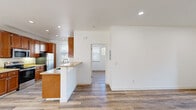 Located at 3440 El Camino Real in Santa Clara, CA, this one-bedroom, one-bathroom unit offers a well-designed single-floor layout with consistent wood-style flooring throughout. The open living area is bright and airy, featuring recessed lighting, large sliding glass doors that open to an outdoor patio, and views of the surrounding neighborhood — filling the space with natural light.

The galley-style kitchen is a standout feature, outfitted with rich, warm-toned cabinetry, granite-style countertops, stainless steel appliances including a refrigerator, electric range, microwave, and dishwasher, along with recessed lighting and a window that lets in additional natural light.

The bedroom is a comfortable size, equipped with a ceiling fan, multiple windows with blinds, a built-in closet, and open shelving, creating a practical and organized retreat. Baseboard heating is present throughout the unit for added comfort year-round.

The bathroom features a vanity with matching warm-toned cabinetry, granite-style countertop, a combined shower and bathtub with a sliding glass enclosure, and a window for natural ventilation. Clean white walls and wood-style flooring carry through cohesively. The unit's layout flows efficiently, making excellent use of its square footage.