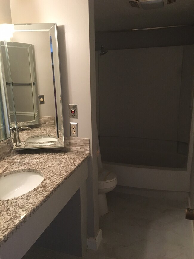 This bathroom has also been remodeled with new paint, a new granite countertop, new faucet, tiled floor, and refurbished shower/bathtub combination. - 4193 Abbey Court