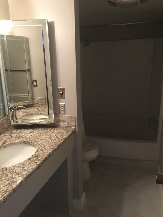 This bathroom has also been remodeled with new paint, a new granite countertop, new faucet, tiled floor, and refurbished shower/bathtub combination. - 4193 Abbey Court