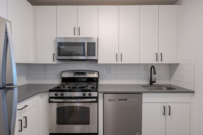 Sleek stainless steel appliances and modern cabinetry - Newport Rentals