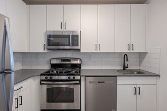 Sleek stainless steel appliances and modern cabinetry - Newport Rentals