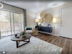 This efficiently designed 600-square-foot, one-bedroom, one-bathroom apartment in DeSoto, Texas offers a well-organized single-floor layout that maximizes every inch of space. The living room features rich wood-style flooring, a textured ceiling, and large sliding glass doors that open to a private balcony, filling the room with natural light and outdoor views. The galley-style kitchen is outfitted with dark cabinetry, white countertops, black appliances including a full-size refrigerator and electric range, and a stainless steel sink — providing ample storage and a functional cooking space. The 150-square-foot primary bedroom accommodates a full-size bed with room to spare, benefits from a natural light window, and connects to a dedicated closet for storage. The bathroom includes a full tub and shower combination with tile surround and wood-style flooring. A dedicated in-unit laundry area houses a full-size top-loading washer and dryer, adding everyday convenience. Throughout the apartment, neutral tones and wood-style flooring create a cohesive and welcoming ambiance, making this apartment a practical and comfortable home in DeSoto, TX.